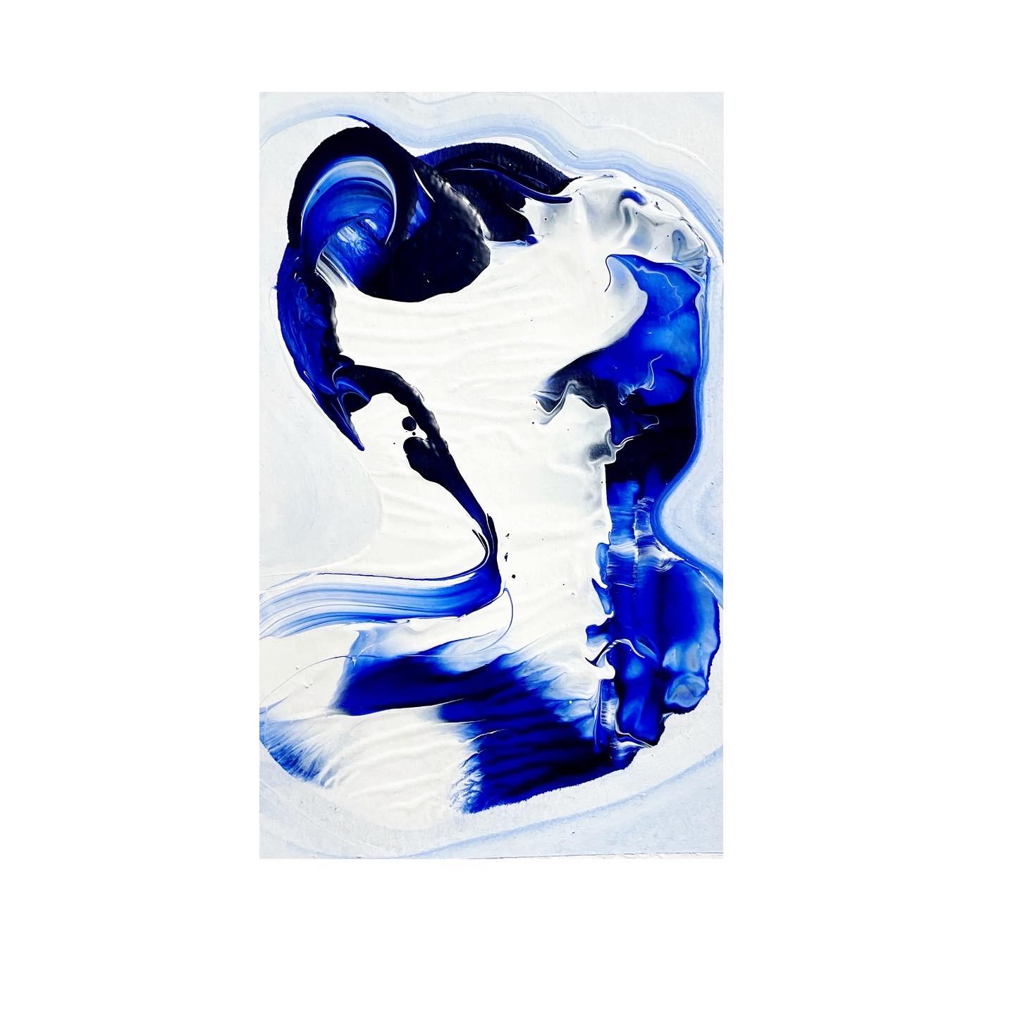 Poured blue paint forming a profile on white