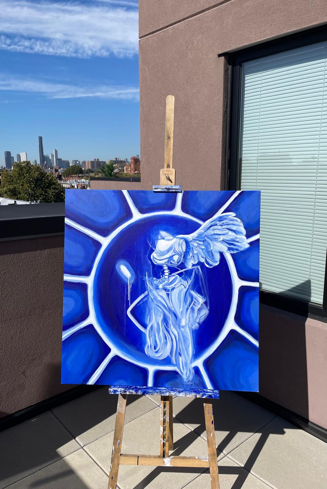 Winged figure inside a circular cobalt composition on an easel