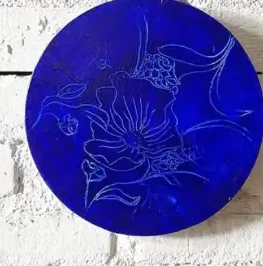 Circular cobalt painting with fine floral outlines