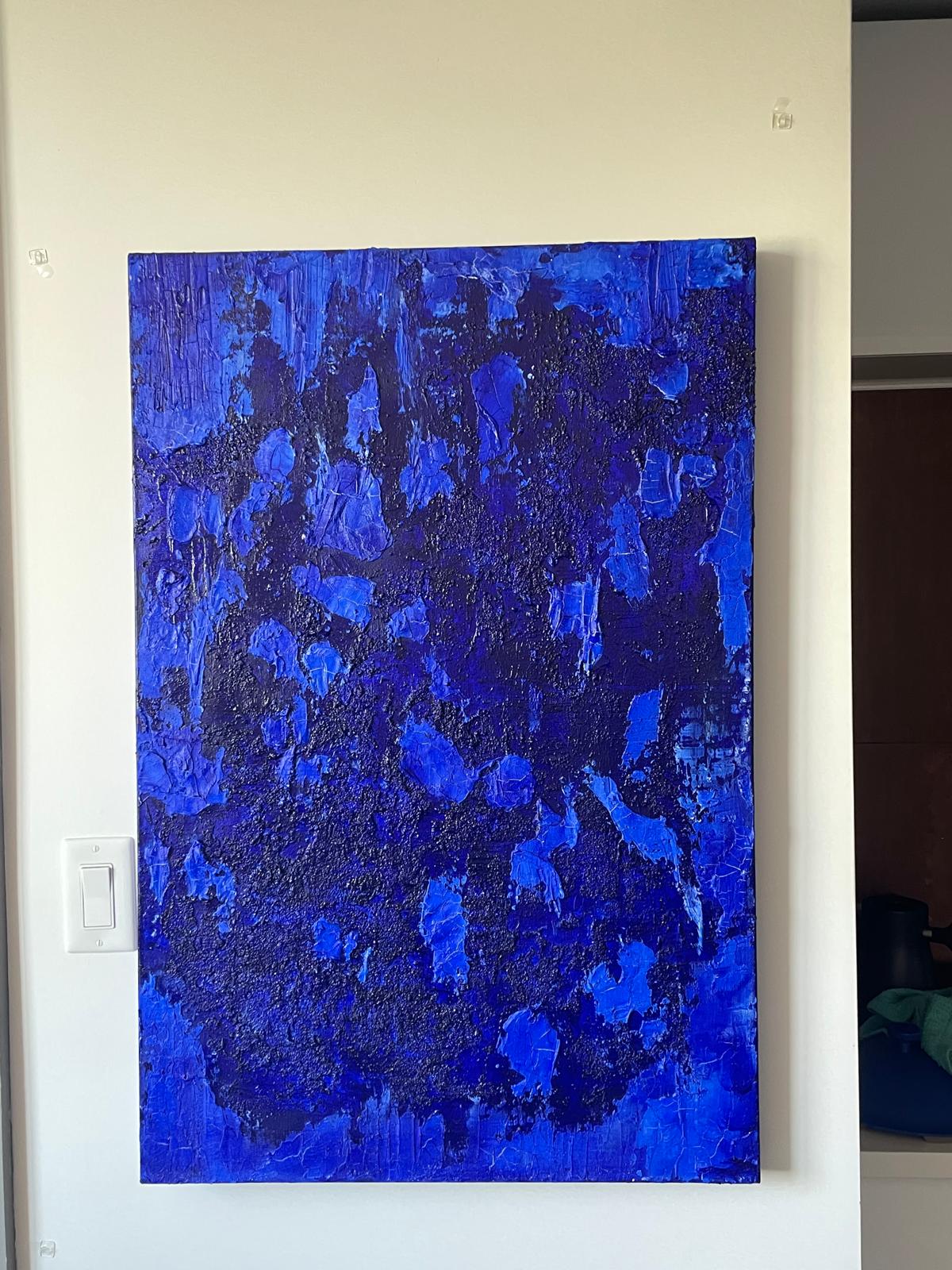 Large textured cobalt painting on a wall