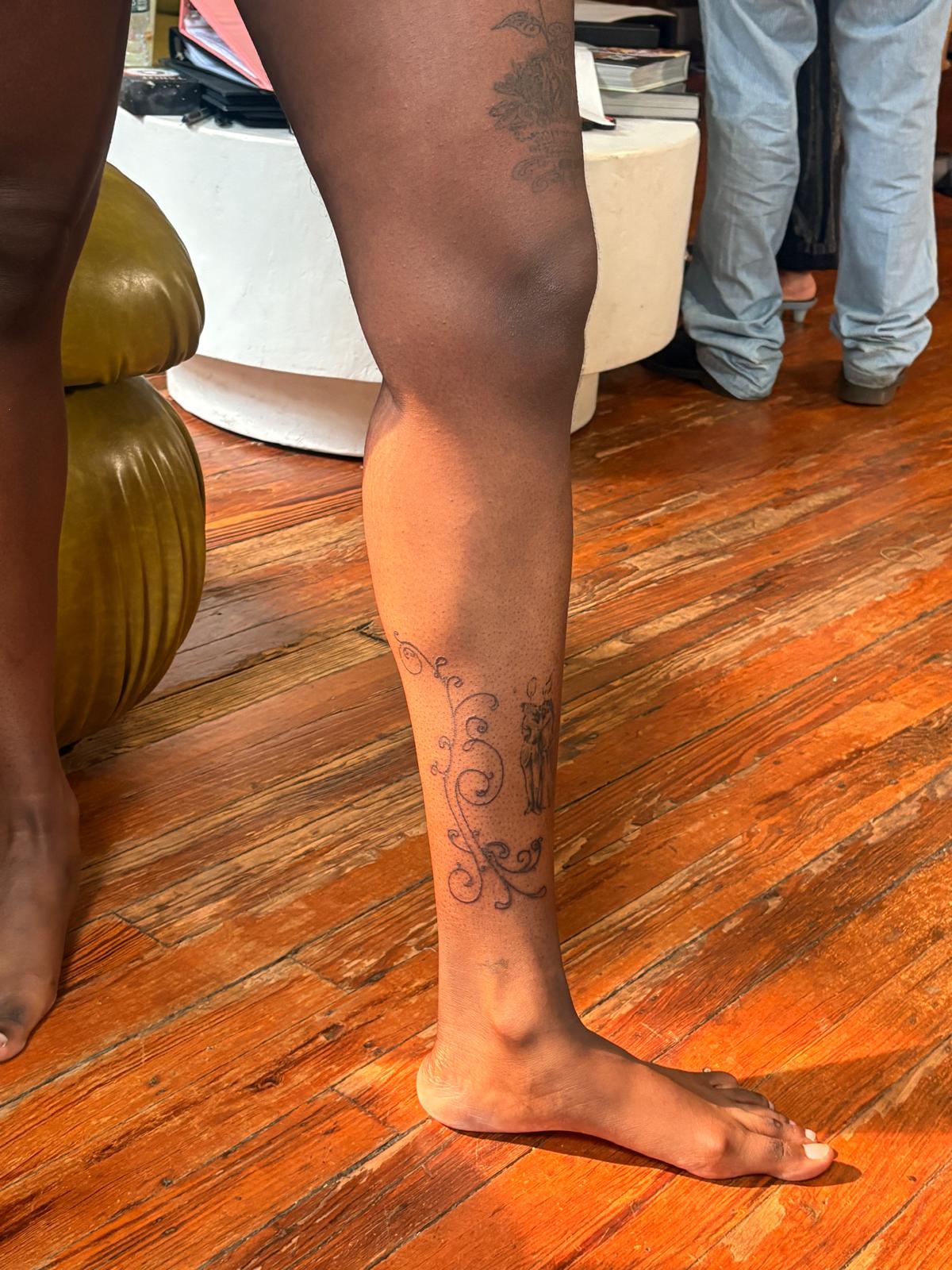 Ornamental fine-line tattoo along a calf