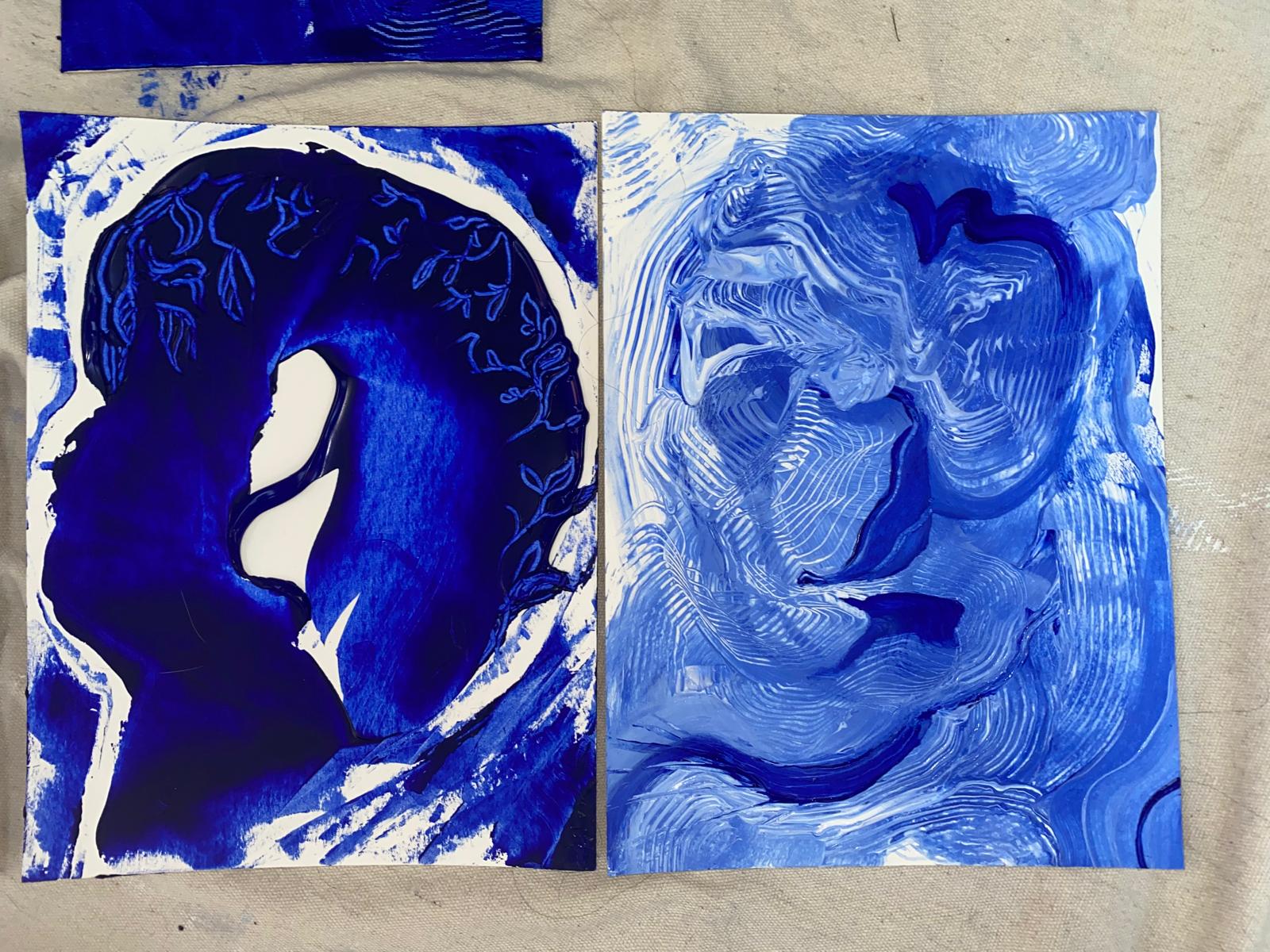 Two blue monoprints of heads in profile