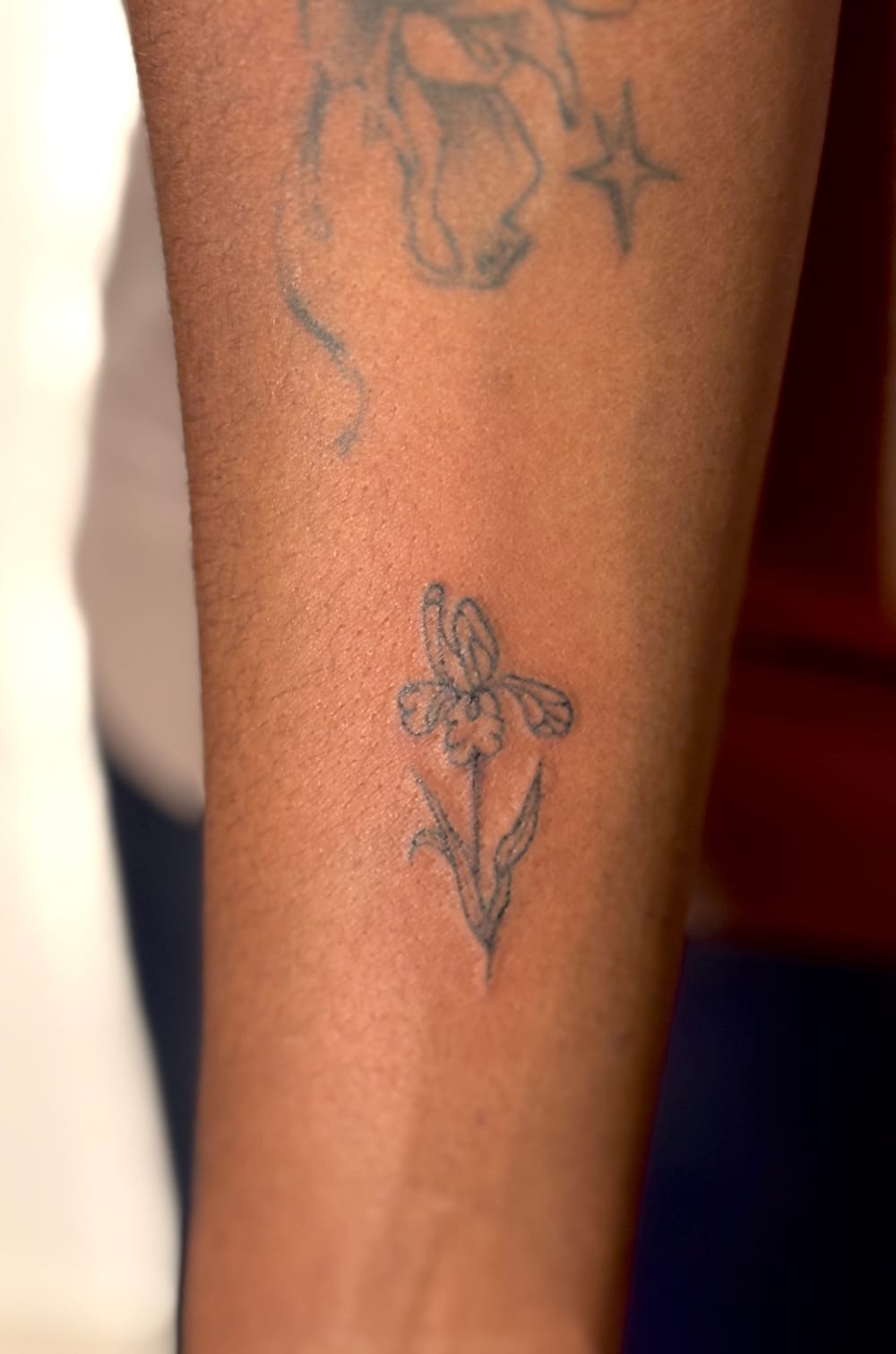 Small fine-line floral tattoo on skin, from Ash Van Eyk’s portfolio