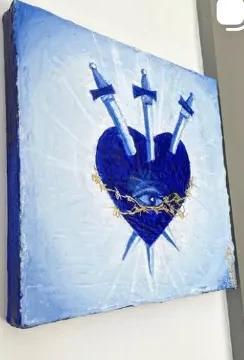 Blue heart pierced by three swords with gold details