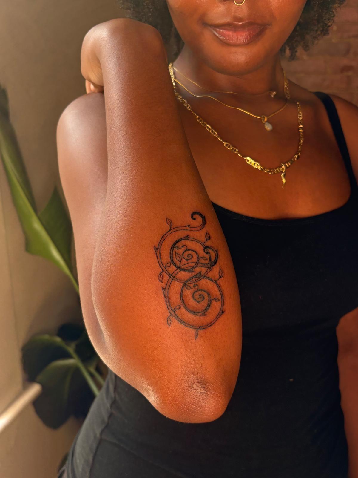 Spiral ornamental tattoo on a forearm